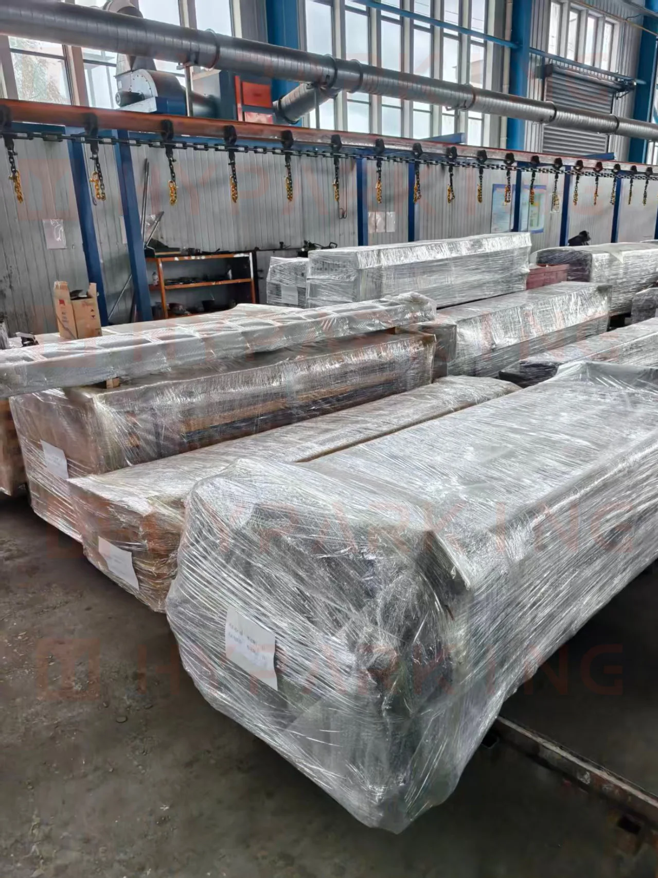 Shrink-wrapped steel parking platforms labeled and staged for the Miami-bound shipment at the Shanghai factory