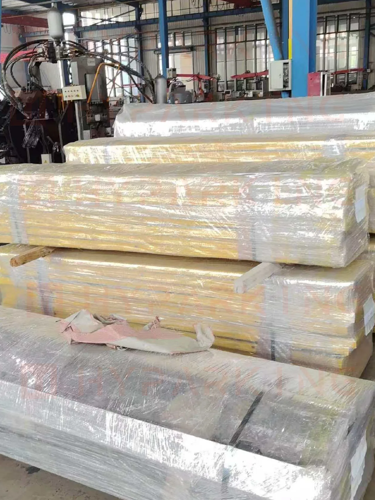 Palletized coated components with wooden spacers and shipping labels, part of the Miami export order